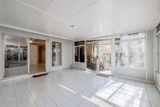 unfurnished sunroom featuring ceiling fan