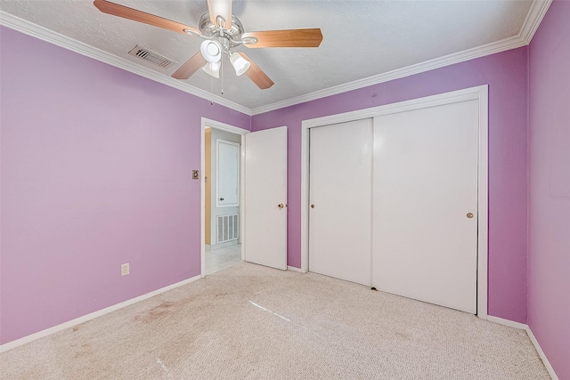 unfurnished bedroom with a closet, ornamental molding, light colored carpet, and ceiling fan