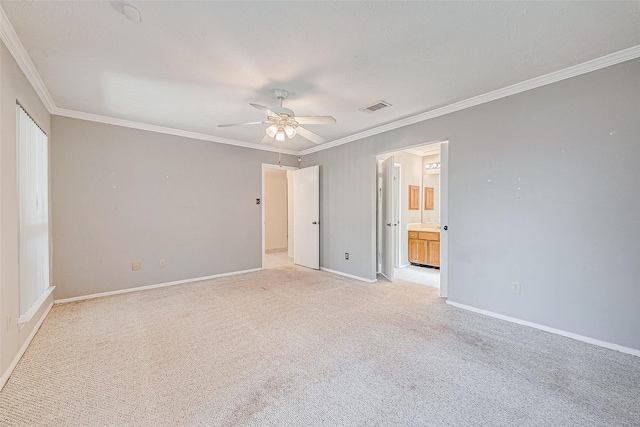 unfurnished bedroom featuring visible vents, light carpet, ornamental molding, connected bathroom, and baseboards