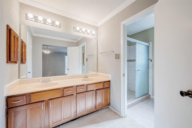 full bath featuring ornamental molding, a stall shower, and a sink