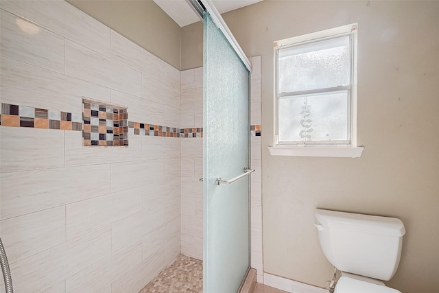 bathroom with walk in shower and toilet