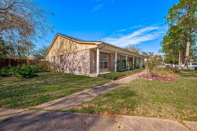 view of side of home with a lawn