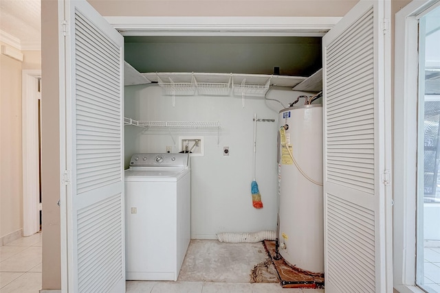 laundry area with light tile patterned floors, water heater, and washer / clothes dryer