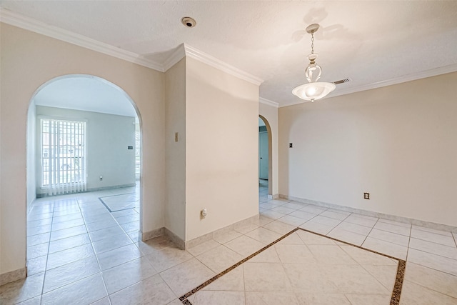 unfurnished room with crown molding, arched walkways, baseboards, and visible vents