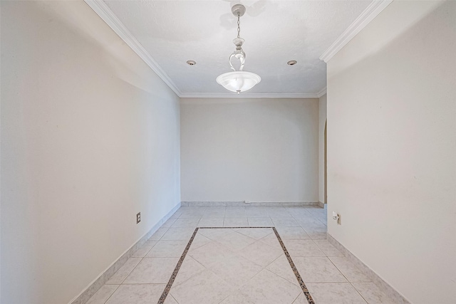 tiled empty room featuring ornamental molding