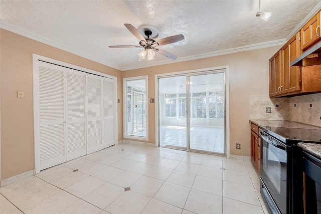 kitchen with ceiling fan, tasteful backsplash, black range with electric stovetop, crown molding, and light tile patterned floors