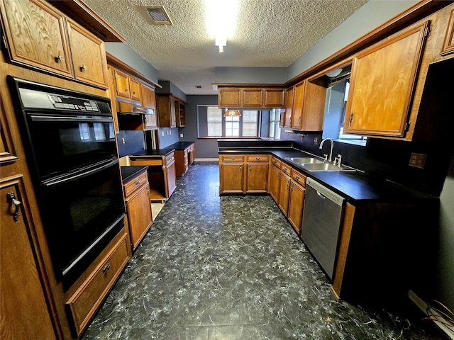 kitchen with stainless steel dishwasher, black double oven, sink, and a textured ceiling