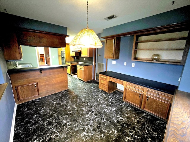 kitchen with built in desk and decorative light fixtures