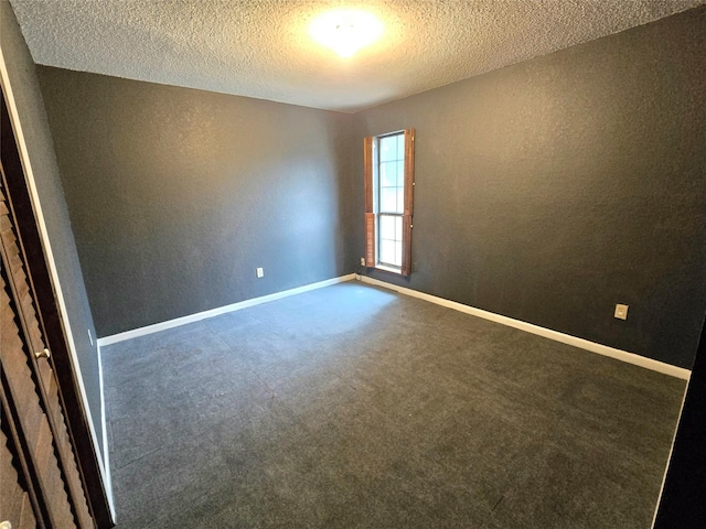 carpeted spare room with a textured ceiling