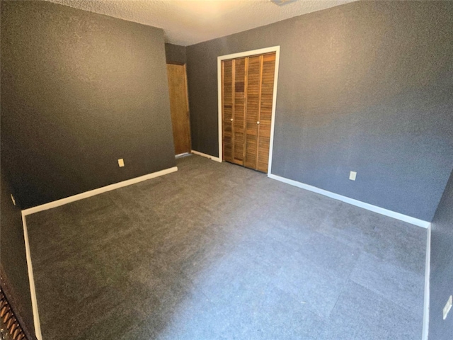 unfurnished bedroom featuring a closet and dark colored carpet