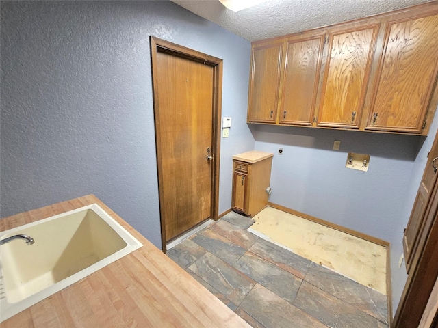 laundry room featuring sink, cabinets, hookup for a washing machine, electric dryer hookup, and a textured ceiling