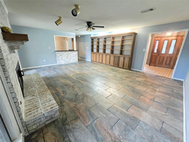 unfurnished living room with ceiling fan