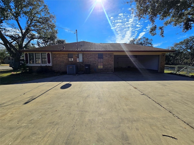 view of front of house featuring cooling unit and a garage