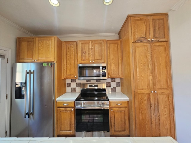 kitchen featuring decorative backsplash, crown molding, and stainless steel appliances