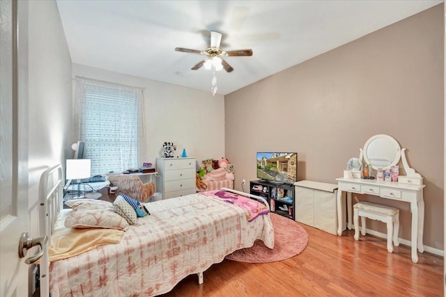 bedroom with ceiling fan and hardwood / wood-style flooring