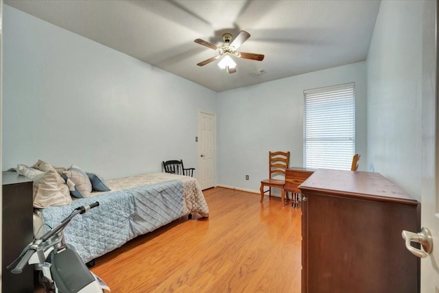 bedroom with ceiling fan and light hardwood / wood-style flooring