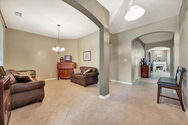 living room featuring light tile patterned floors and a notable chandelier