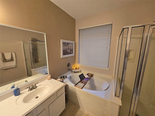 bathroom featuring vanity and independent shower and bath