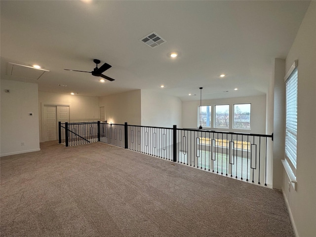 empty room with ceiling fan and carpet floors