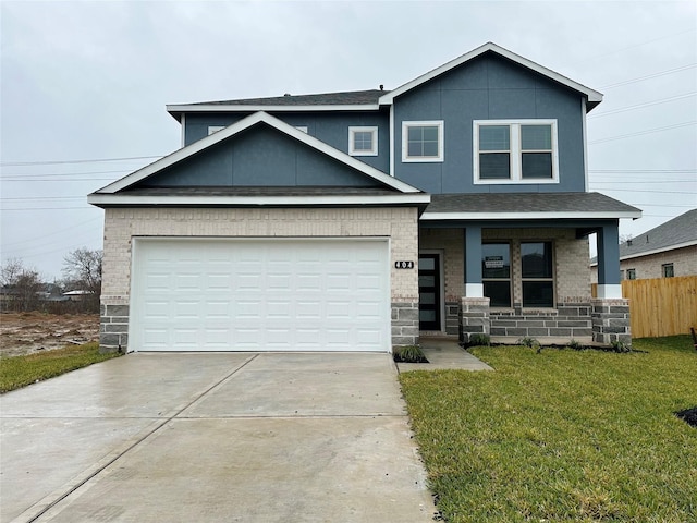 view of front of property with a porch, a garage, and a front lawn