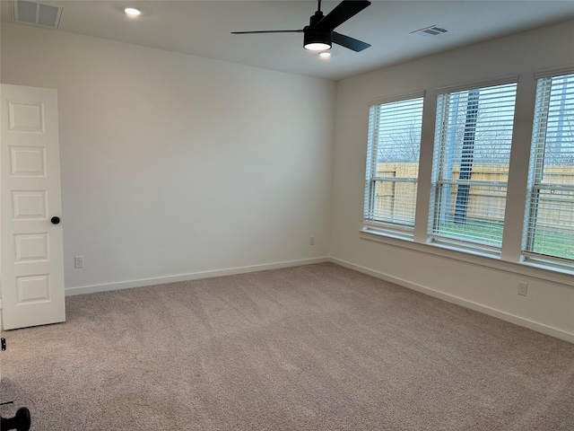 empty room featuring ceiling fan and carpet floors