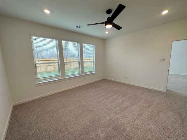 empty room featuring carpet flooring and ceiling fan