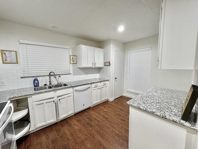 kitchen featuring white appliances, white cabinetry, and sink