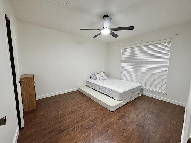 unfurnished bedroom with dark hardwood / wood-style floors and ceiling fan