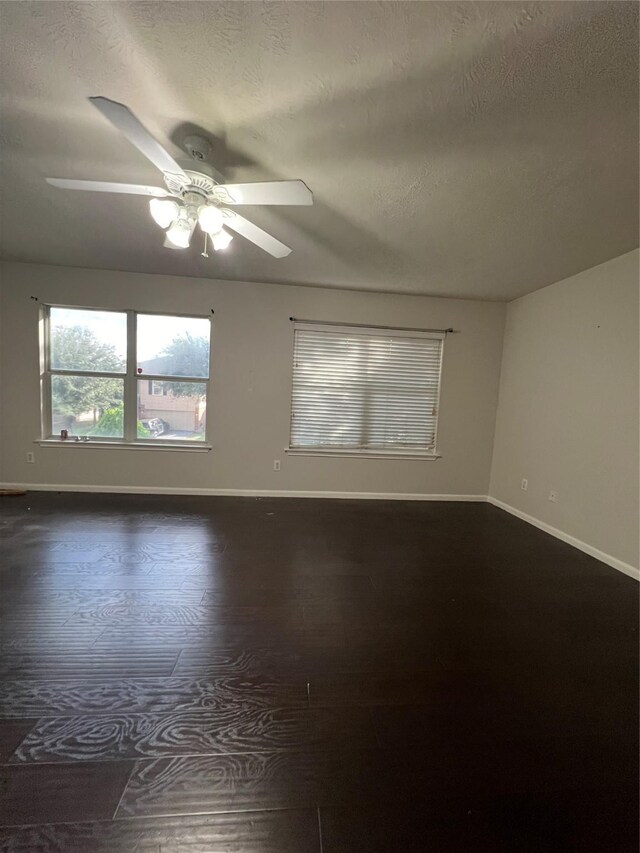 empty room with a textured ceiling and ceiling fan