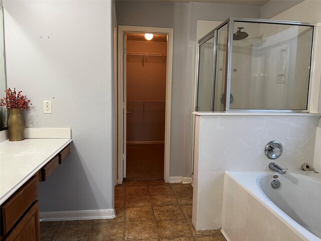 bathroom featuring separate shower and tub and vanity