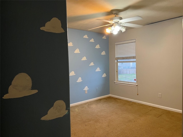 unfurnished room with carpet flooring and ceiling fan