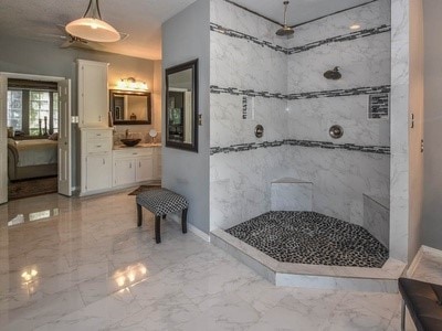 bathroom featuring vanity and tiled shower