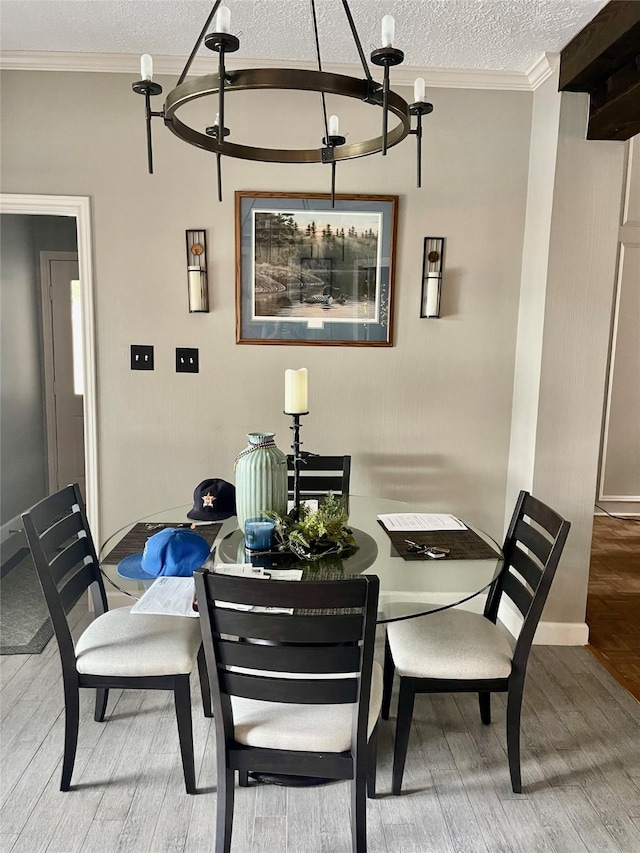 dining room with hardwood / wood-style flooring, crown molding, and a textured ceiling