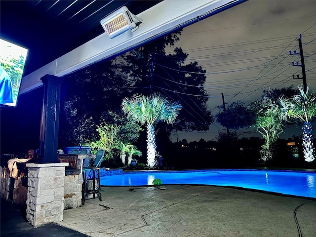 view of pool with a patio area and a bar