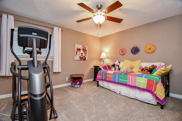 carpeted bedroom featuring ceiling fan and a textured ceiling