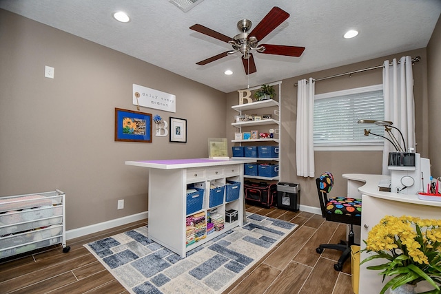 office space with a textured ceiling and ceiling fan