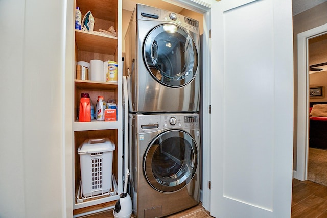 washroom featuring stacked washer and dryer and hardwood / wood-style floors