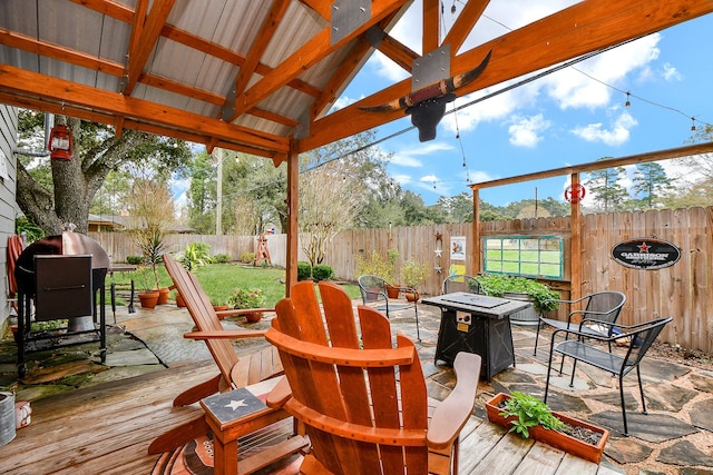 wooden deck with ceiling fan, area for grilling, a gazebo, and a patio area