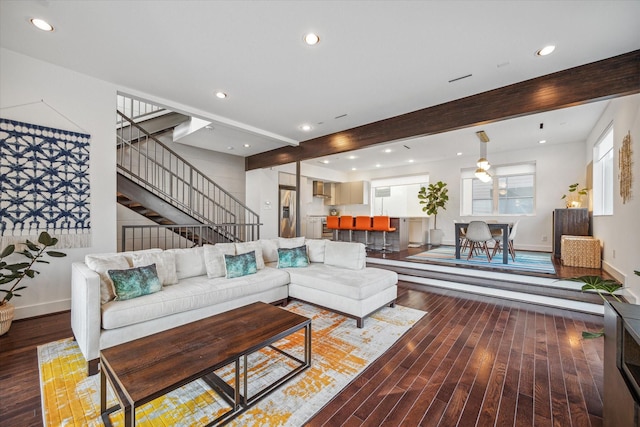 living room featuring beamed ceiling and hardwood / wood-style floors