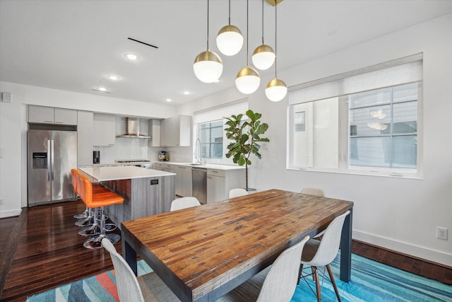 dining area with dark hardwood / wood-style flooring and sink