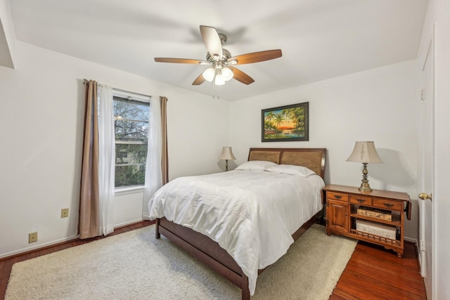 bedroom with ceiling fan and dark hardwood / wood-style floors