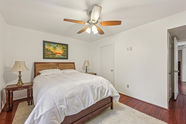 bedroom with dark hardwood / wood-style floors and ceiling fan