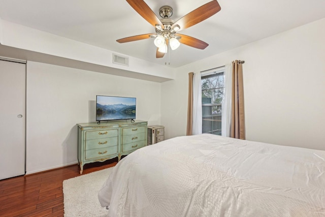 bedroom with ceiling fan and dark hardwood / wood-style floors