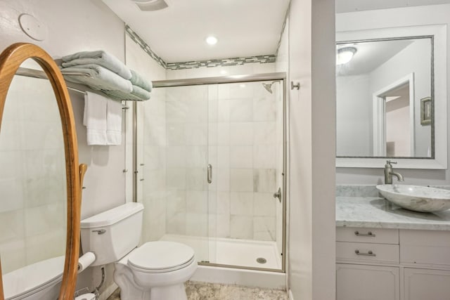 bathroom featuring vanity, toilet, and walk in shower