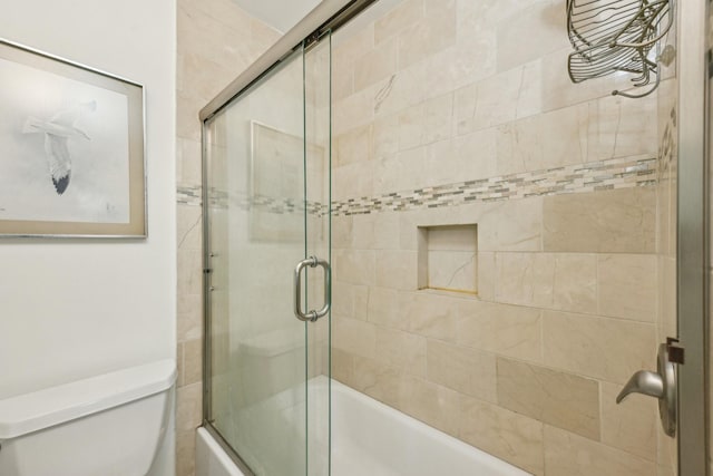 bathroom with toilet and enclosed tub / shower combo