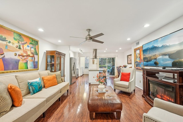 living room with ceiling fan and hardwood / wood-style flooring