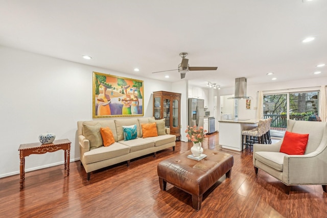 living room featuring hardwood / wood-style floors and ceiling fan