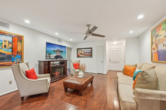 living room featuring hardwood / wood-style floors and ceiling fan