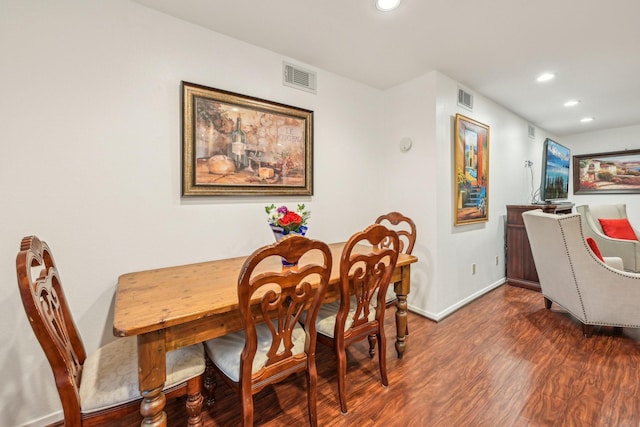 dining space with dark wood-type flooring