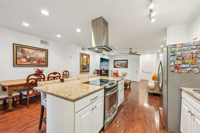 kitchen featuring a kitchen breakfast bar, dark hardwood / wood-style flooring, stainless steel appliances, island range hood, and white cabinetry